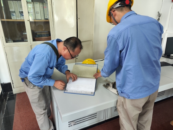 師帶徒，8月21日，老師傅王益在一期控制室為新員工胡含朗講解儀表設(shè)備圖紙.jpg